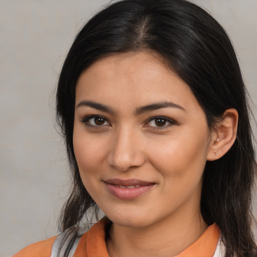 Joyful latino young-adult female with medium  brown hair and brown eyes