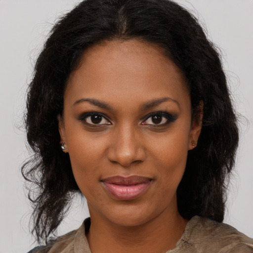 Joyful black young-adult female with medium  brown hair and brown eyes