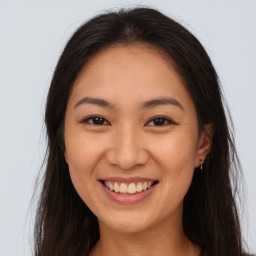 Joyful white young-adult female with long  brown hair and brown eyes