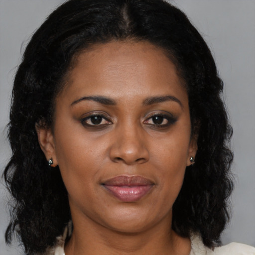 Joyful black young-adult female with medium  brown hair and brown eyes