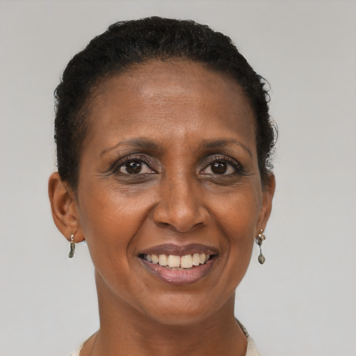 Joyful black adult female with short  brown hair and brown eyes