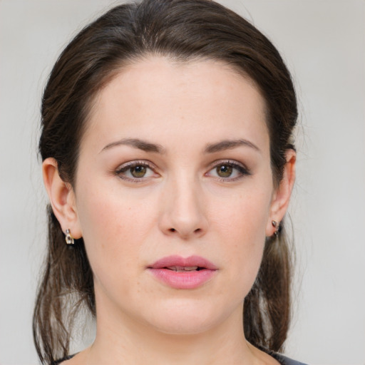 Joyful white young-adult female with medium  brown hair and green eyes