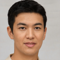 Joyful asian young-adult male with short  black hair and brown eyes