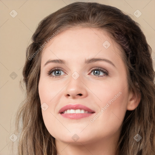 Joyful white young-adult female with long  brown hair and blue eyes