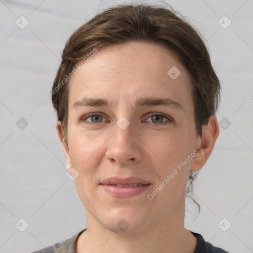 Joyful white young-adult female with short  brown hair and grey eyes