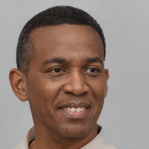 Joyful latino adult male with short  black hair and brown eyes