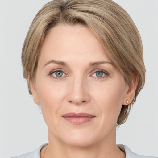 Joyful white adult female with medium  brown hair and grey eyes