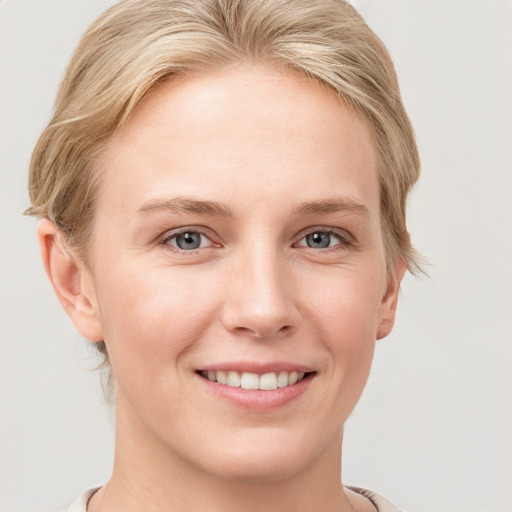 Joyful white young-adult female with medium  brown hair and blue eyes