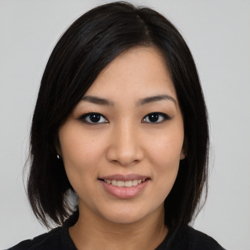Joyful asian young-adult female with medium  black hair and brown eyes