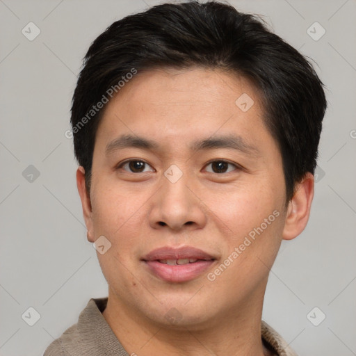 Joyful asian young-adult male with short  brown hair and brown eyes