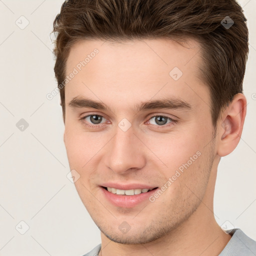 Joyful white young-adult male with short  brown hair and brown eyes