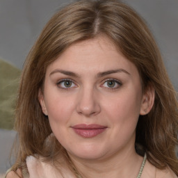 Joyful white young-adult female with medium  brown hair and grey eyes