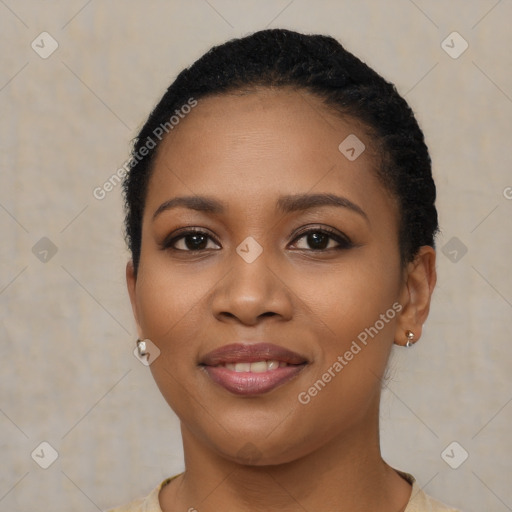 Joyful black young-adult female with short  brown hair and brown eyes