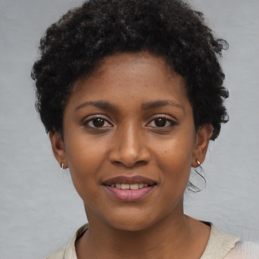 Joyful black young-adult female with short  brown hair and brown eyes