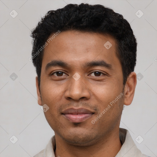 Joyful latino young-adult male with short  black hair and brown eyes