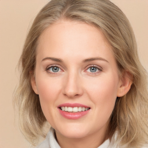 Joyful white young-adult female with medium  brown hair and blue eyes