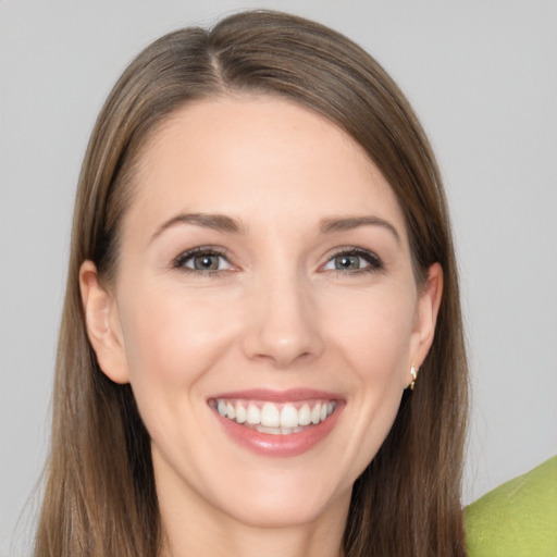 Joyful white young-adult female with long  brown hair and brown eyes