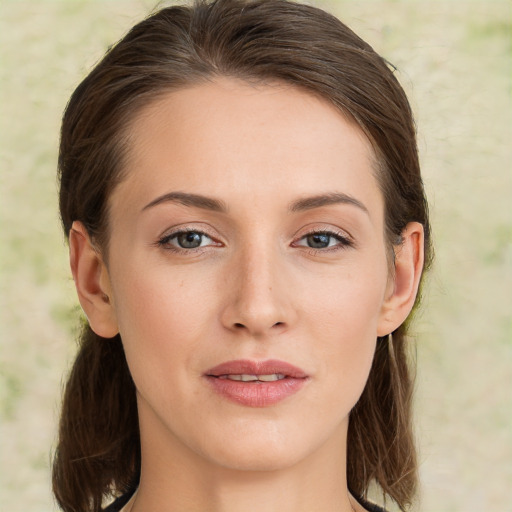 Joyful white young-adult female with medium  brown hair and green eyes