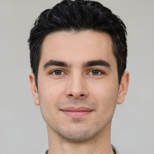 Joyful white young-adult male with short  black hair and brown eyes