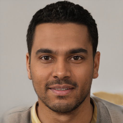Joyful latino young-adult male with short  black hair and brown eyes