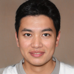 Joyful asian young-adult male with short  black hair and brown eyes