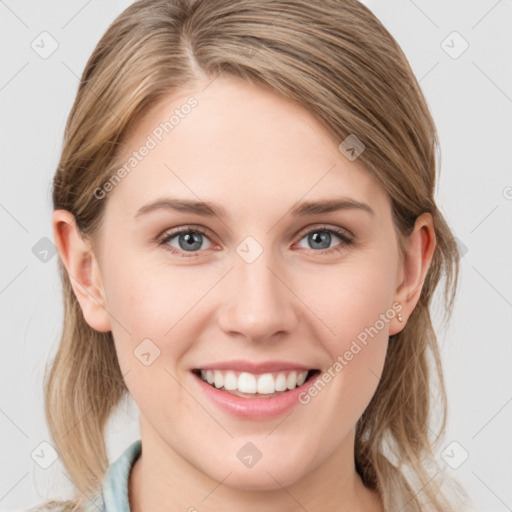 Joyful white young-adult female with medium  brown hair and blue eyes