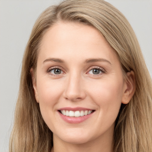 Joyful white young-adult female with long  brown hair and grey eyes