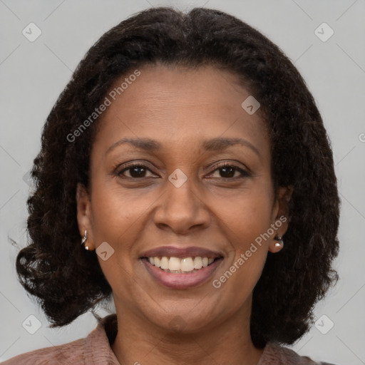 Joyful black adult female with medium  brown hair and brown eyes