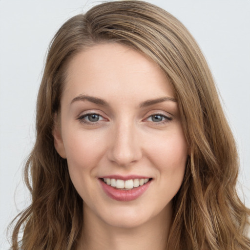 Joyful white young-adult female with long  brown hair and grey eyes