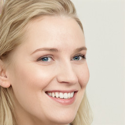 Joyful white young-adult female with long  brown hair and blue eyes