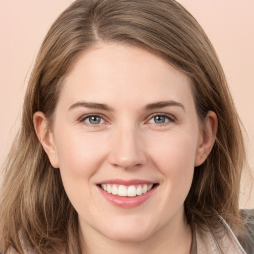 Joyful white young-adult female with long  brown hair and grey eyes