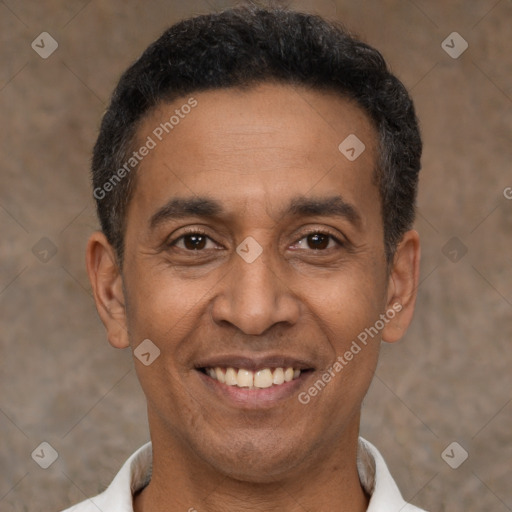 Joyful latino adult male with short  black hair and brown eyes