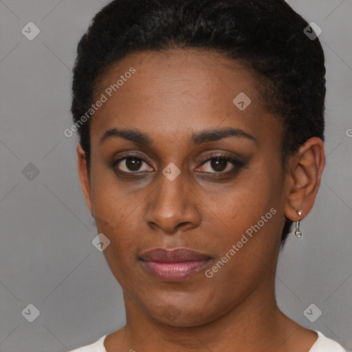 Joyful black young-adult female with short  brown hair and brown eyes