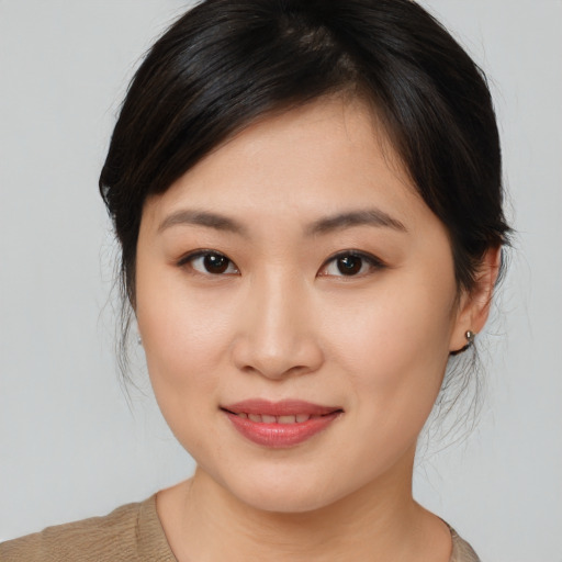 Joyful asian young-adult female with medium  brown hair and brown eyes