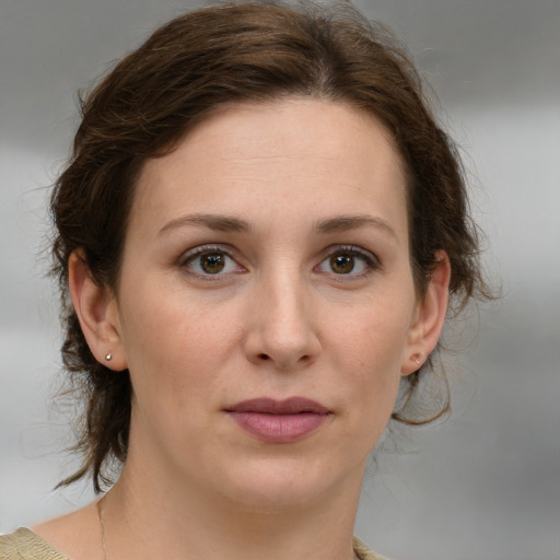 Joyful white young-adult female with medium  brown hair and green eyes