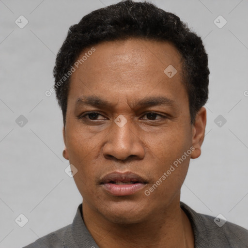 Neutral latino adult male with short  black hair and brown eyes