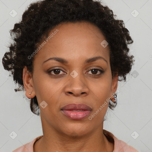 Joyful black adult female with short  brown hair and brown eyes