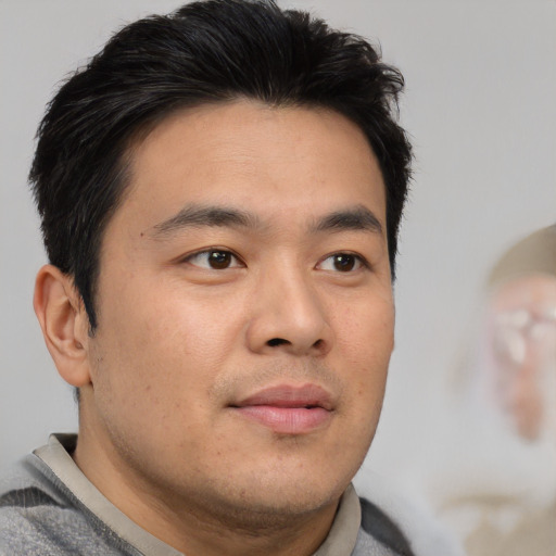 Neutral asian young-adult male with short  brown hair and brown eyes