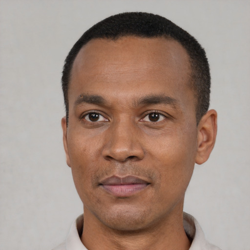 Joyful latino adult male with short  black hair and brown eyes