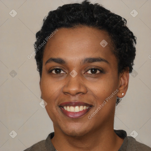 Joyful black young-adult female with short  black hair and brown eyes