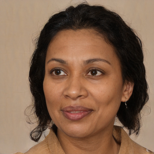 Joyful black adult female with medium  brown hair and brown eyes