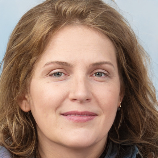 Joyful white adult female with long  brown hair and grey eyes