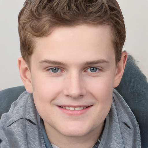 Joyful white young-adult male with short  brown hair and blue eyes