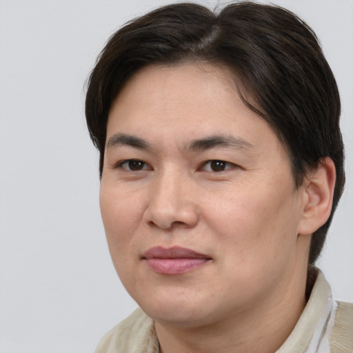 Joyful white adult female with medium  brown hair and brown eyes
