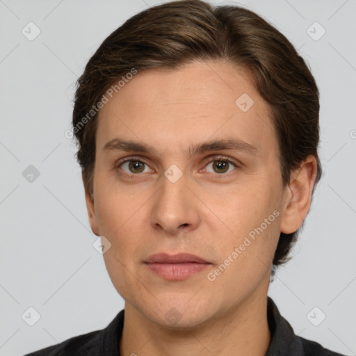 Joyful white adult male with short  brown hair and grey eyes