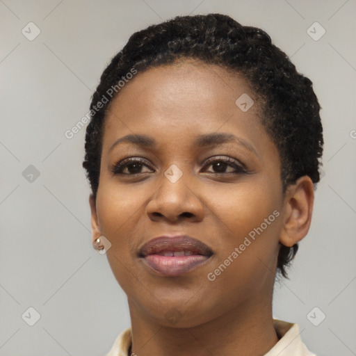 Joyful black young-adult female with short  black hair and brown eyes