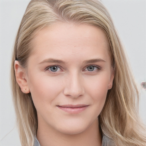 Joyful white young-adult female with long  brown hair and blue eyes