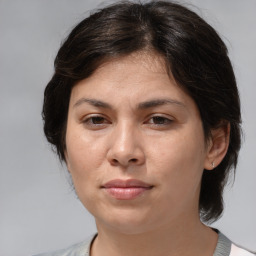 Joyful white adult female with medium  brown hair and brown eyes