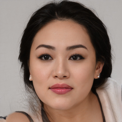 Joyful asian young-adult female with long  black hair and brown eyes