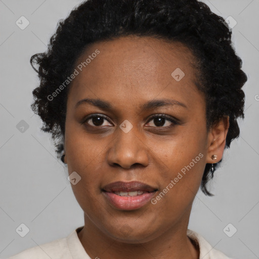 Joyful black young-adult female with short  black hair and brown eyes